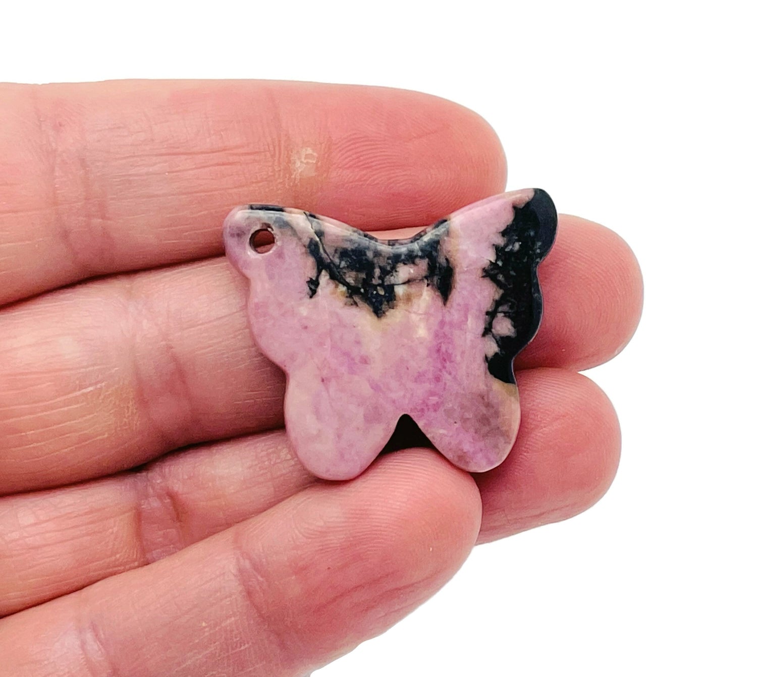 Rhodonite butterfly gemstone pendant with hole crystal jewelry, featuring a vibrant pink and black stone on a silver chain.