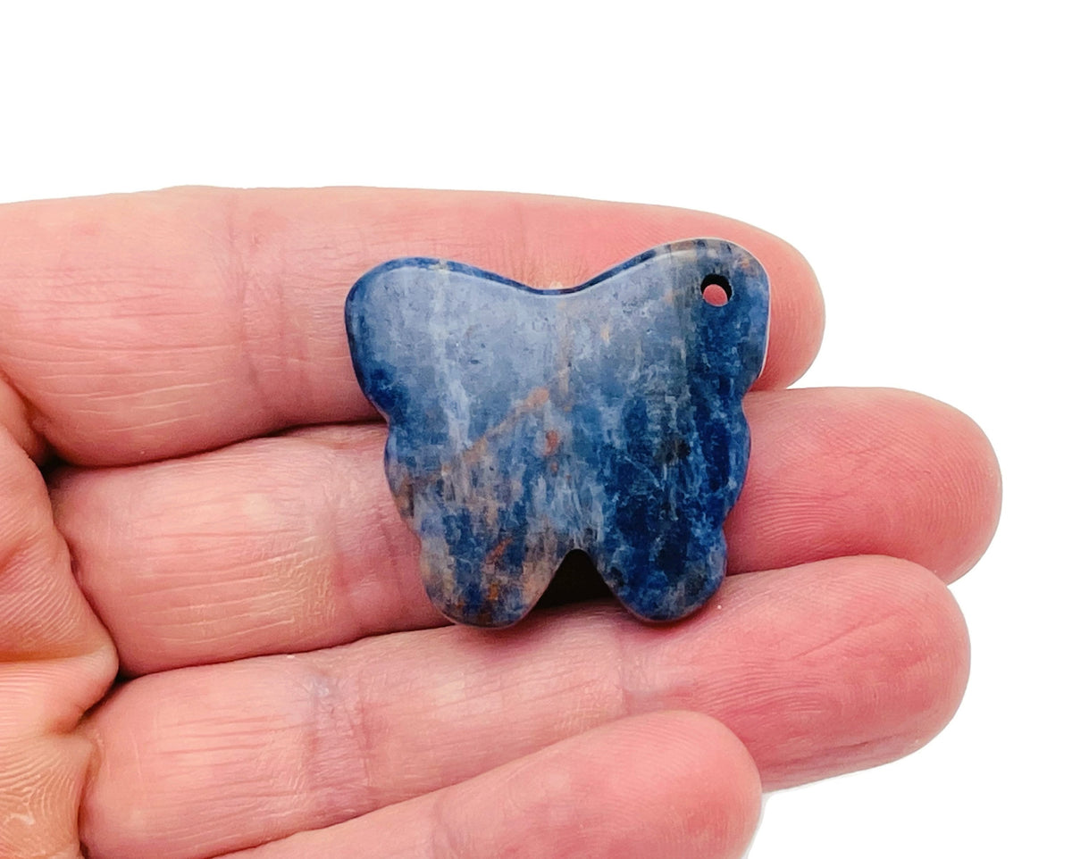 Sodalite butterfly gemstone pendant with hole crystal jewelry, showcasing a blue and white patterned gemstone on a silver chain.
