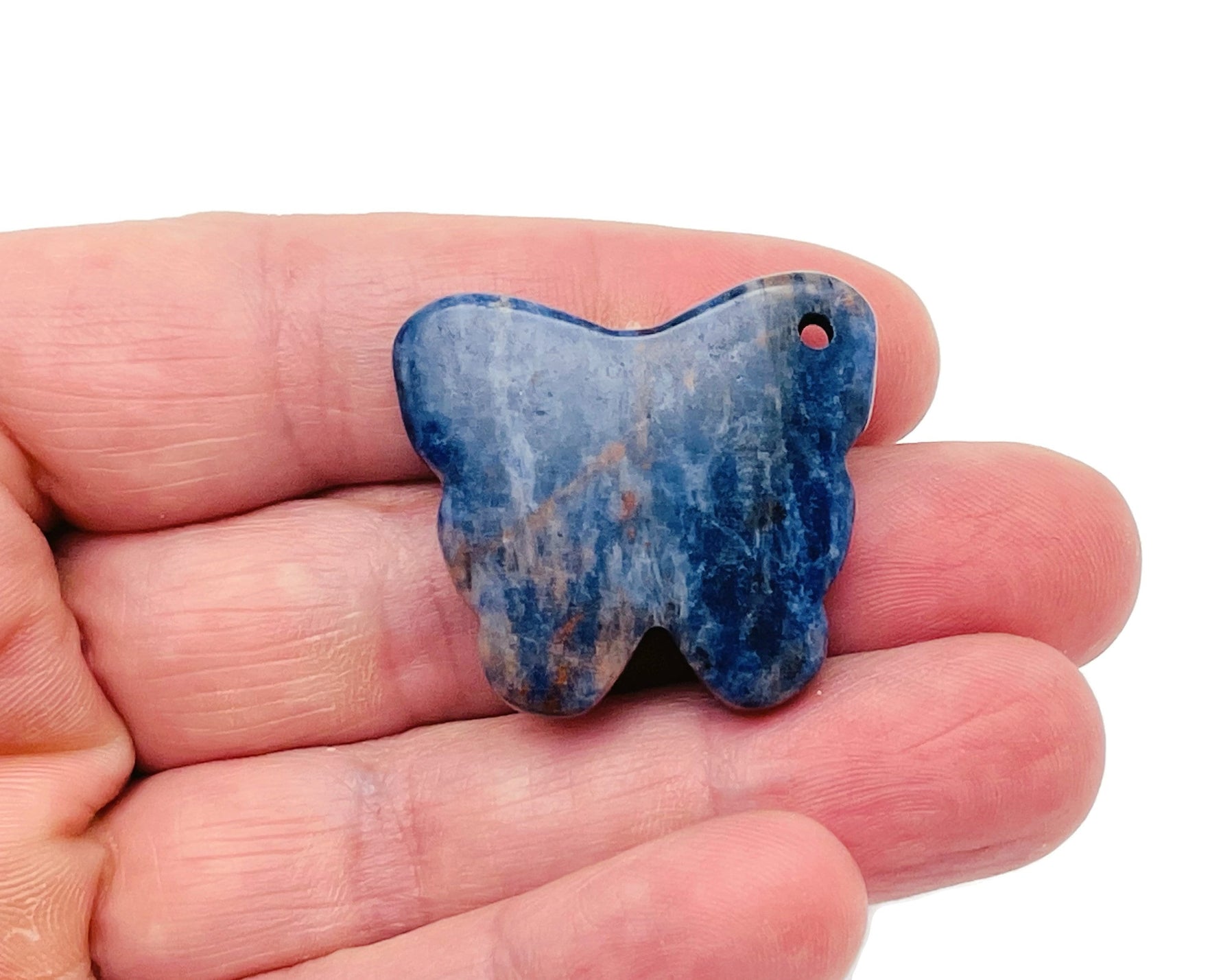 Sodalite butterfly gemstone pendant with hole crystal jewelry, showcasing a blue and white patterned gemstone on a silver chain.