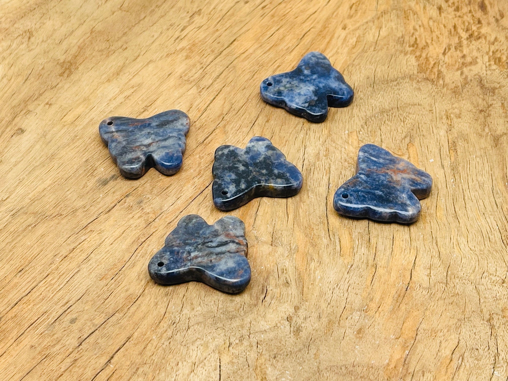 Sodalite butterfly gemstone pendant with hole for jewelry, featuring vibrant blue and white crystal patterns, by GemstoneGO.