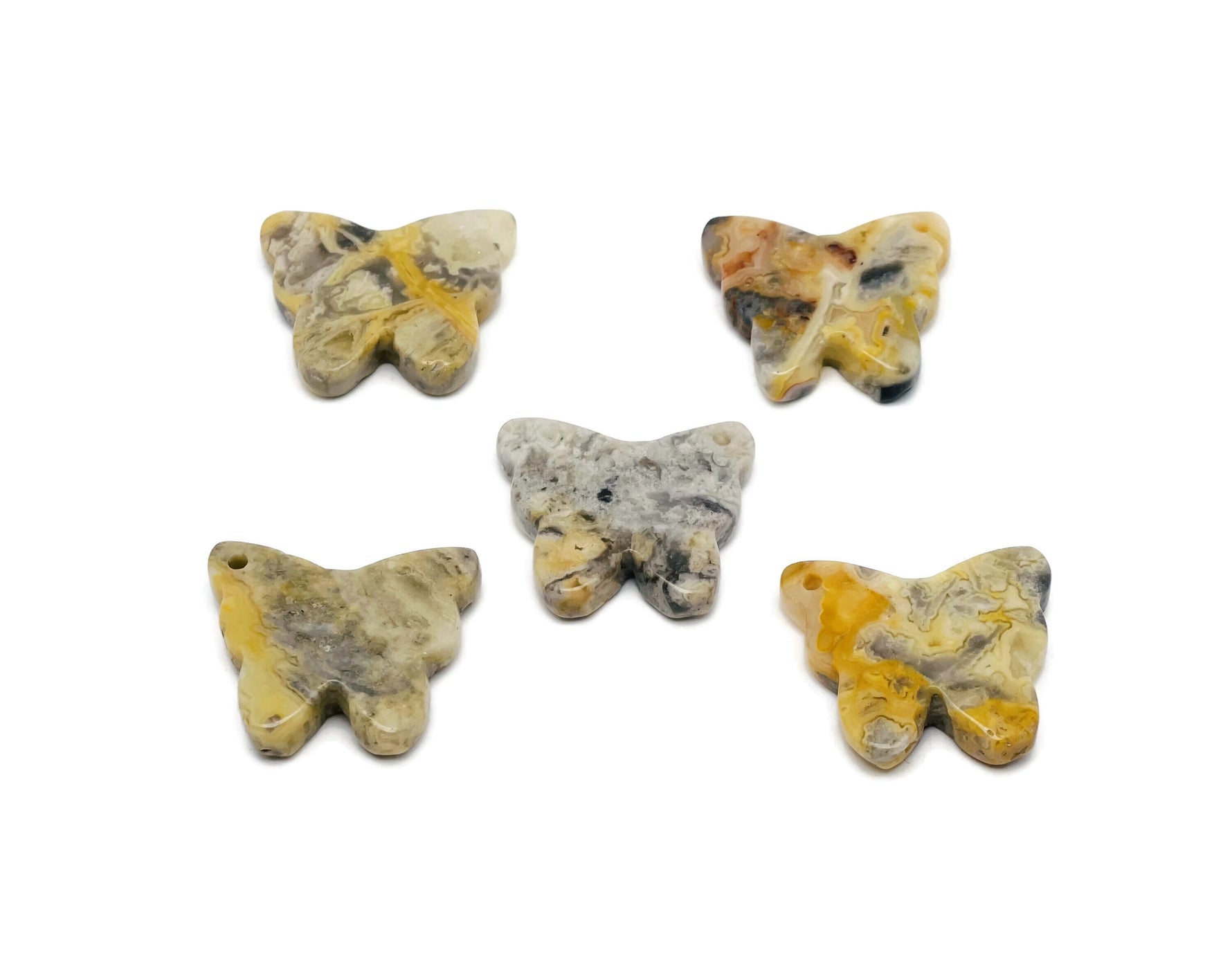 Crazy Lace Agate butterfly gemstone pendant from GemstoneGO featuring a colorful hole crystal jewelry design.