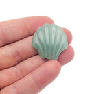 A 30mm Aventurine sea shell carving gemstone from GemstoneGO, showing intricate shell details and vibrant green color.