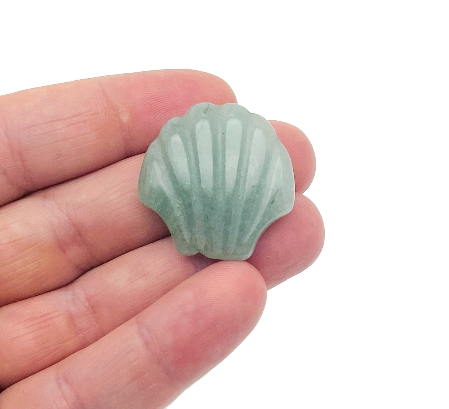 A 30mm Aventurine sea shell carving gemstone from GemstoneGO, showing intricate shell details and vibrant green color.