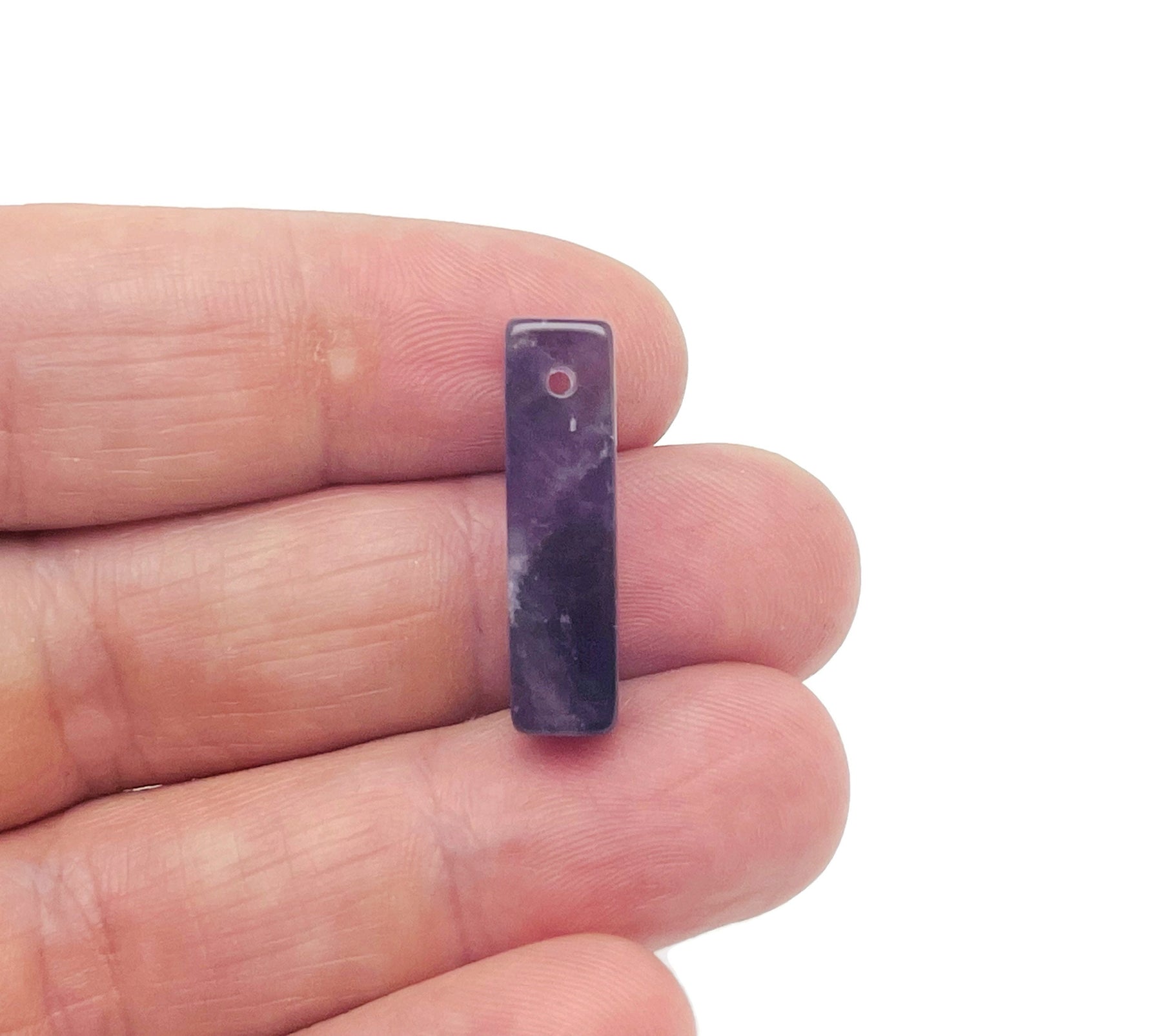 Amethyst crystal pendant from GemstoneGO, drilled for jewelry making, showcasing a purple gemstone with natural facets and a silver bail.