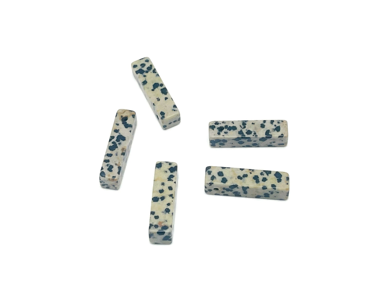 Dalmatian Jasper crystal pendant with drilled hole, showcasing black spots on cream stone, ideal for jewelry making by GemstoneGO.