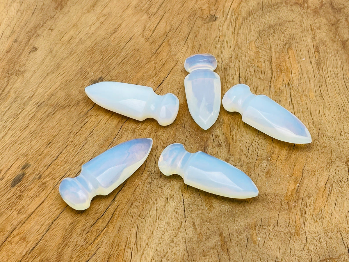 Opalite gemstone dagger with carved sword design, 50mm length, showcasing a smooth, iridescent carved gemstone blade.