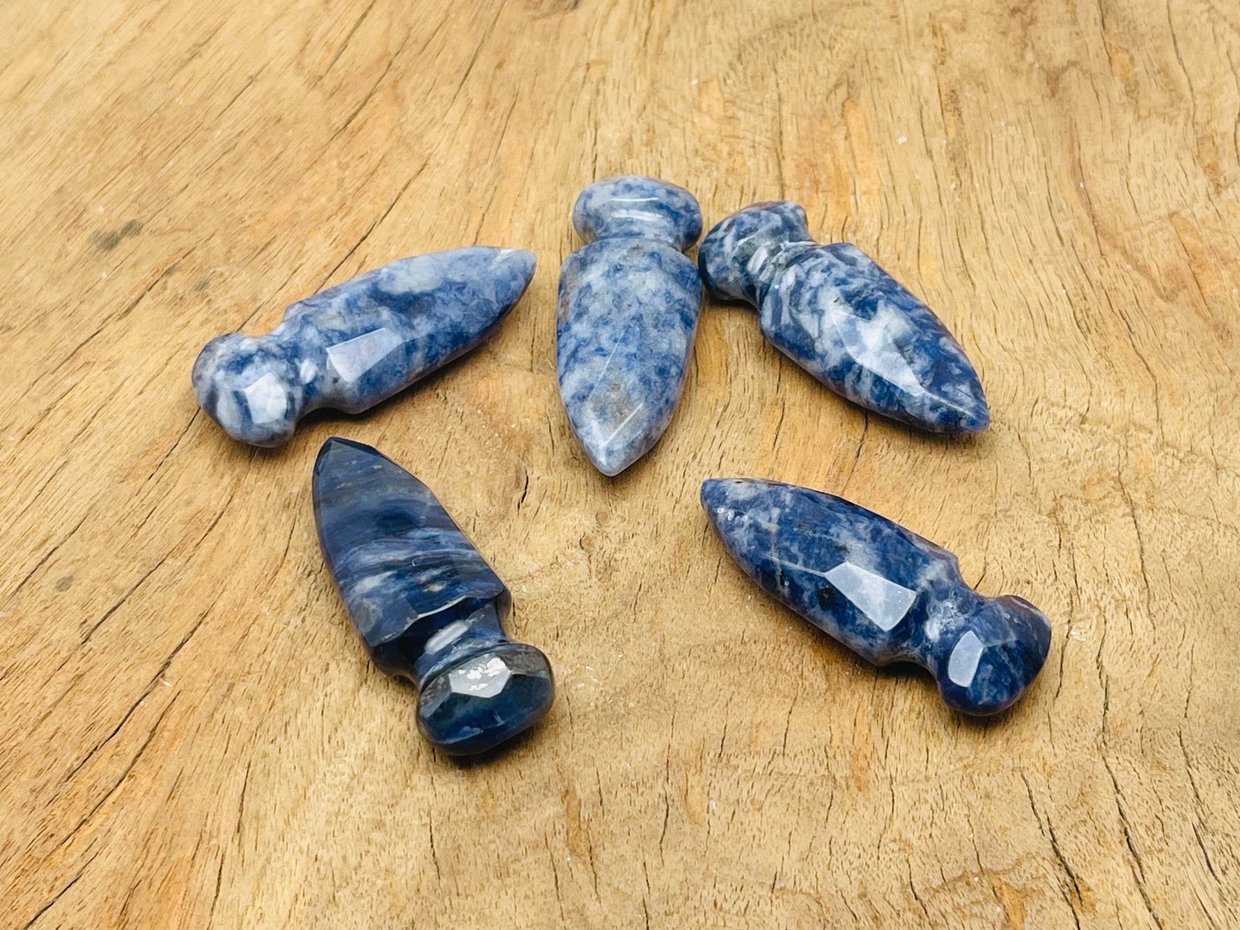 Carved Sodalite sword dagger gemstone pendant, 50mm, with intricate details and vibrant blue and white gemstone patterns.