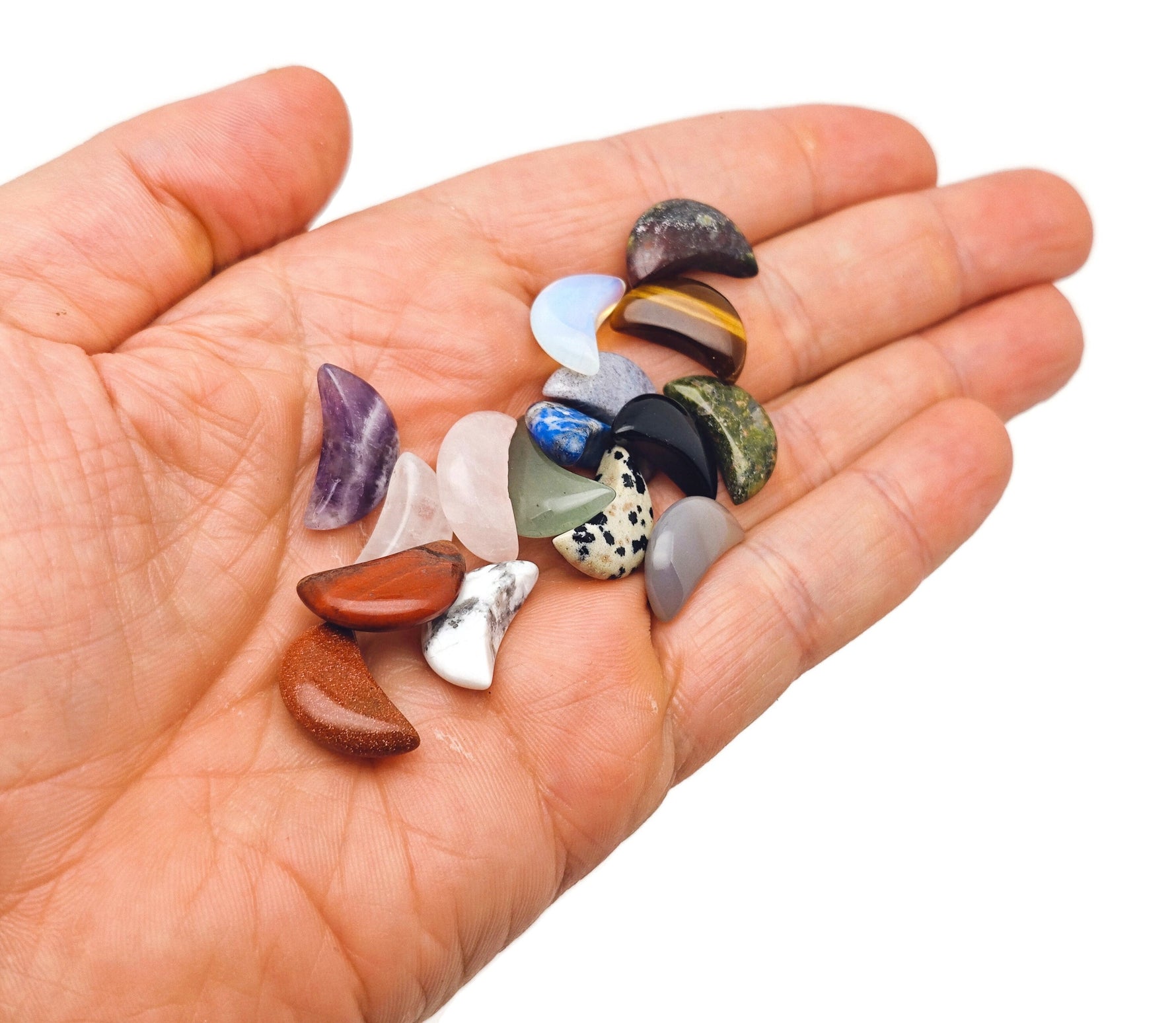 Set of 10 assorted gemstone crystals from GemstoneGO's Crystal Mystery Box Gift featuring moon carvings and healing stones.