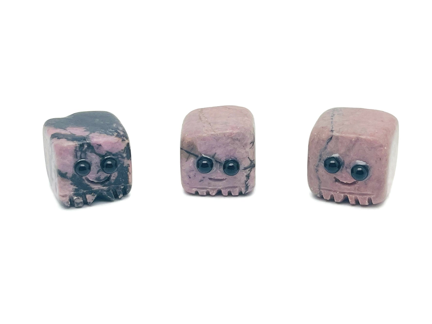 Handmade Rhodonite gemstone carving skull with detailed features, suitable as a crystal gift for kids, by GemstoneGO.