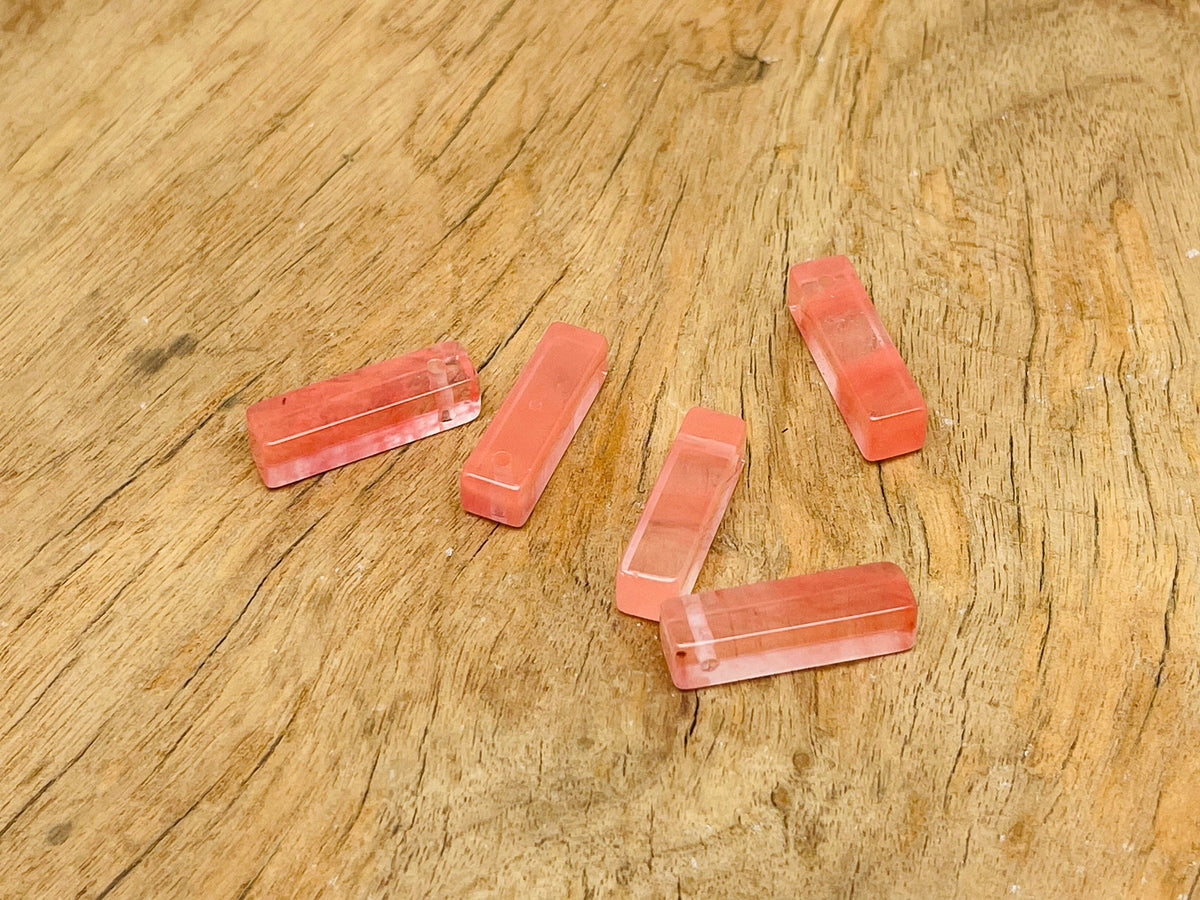 Cherry quartz crystal pendant from GemstoneGO, drilled gemstone jewelry piece with vibrant red color and smooth polished surface.