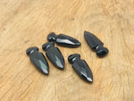 Carved obsidian sword dagger gemstone, 50mm, with intricate details, from GemstoneGO, showcasing a polished, dark stone blade and handle.