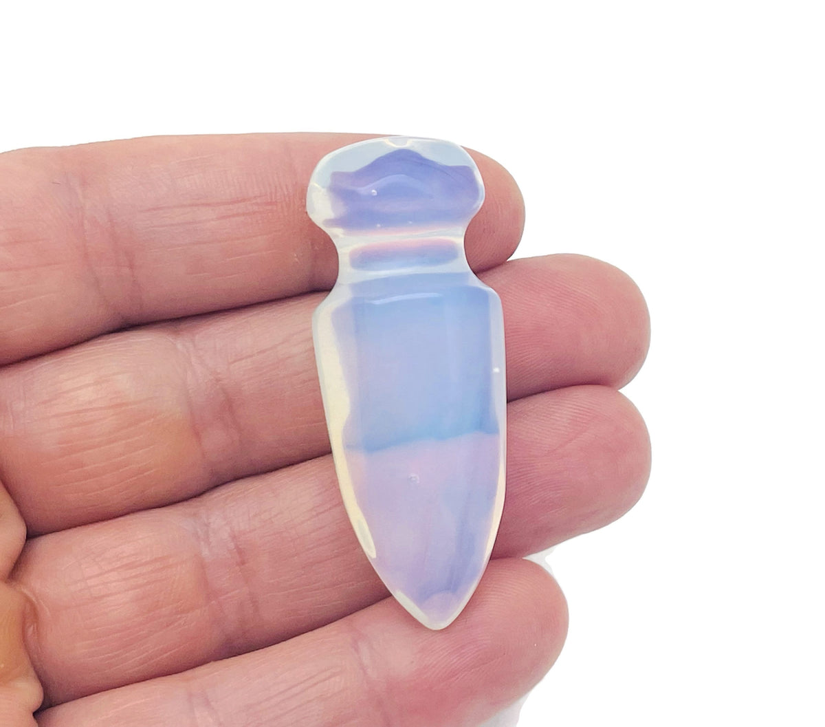 Opalite gemstone dagger with carved sword design, 50mm size, showcasing intricate details and a smooth polished finish.