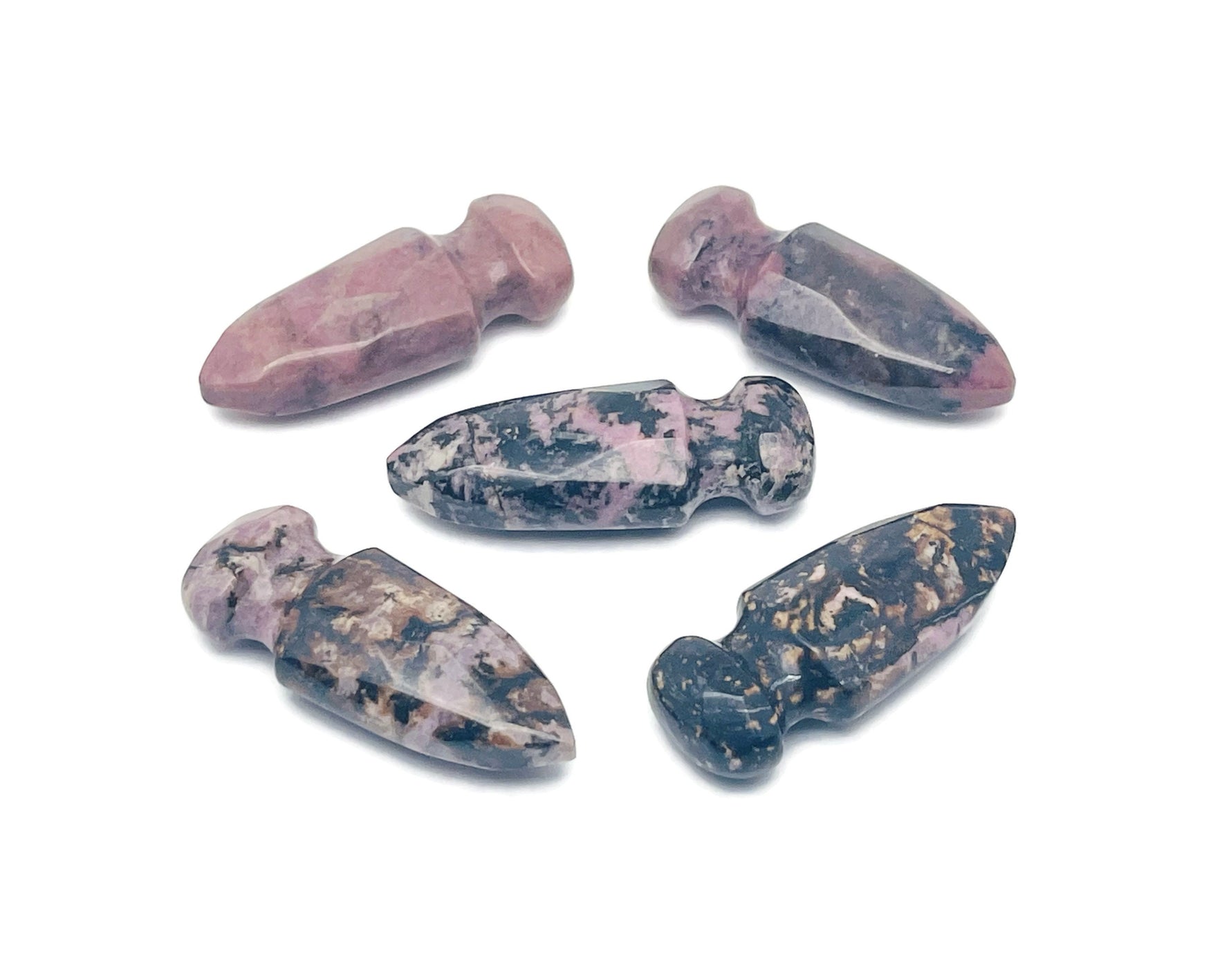 Carved Rhodonite sword dagger gemstone pendant, 50mm, with detailed craftsmanship and vibrant pink and black gemstone colors.