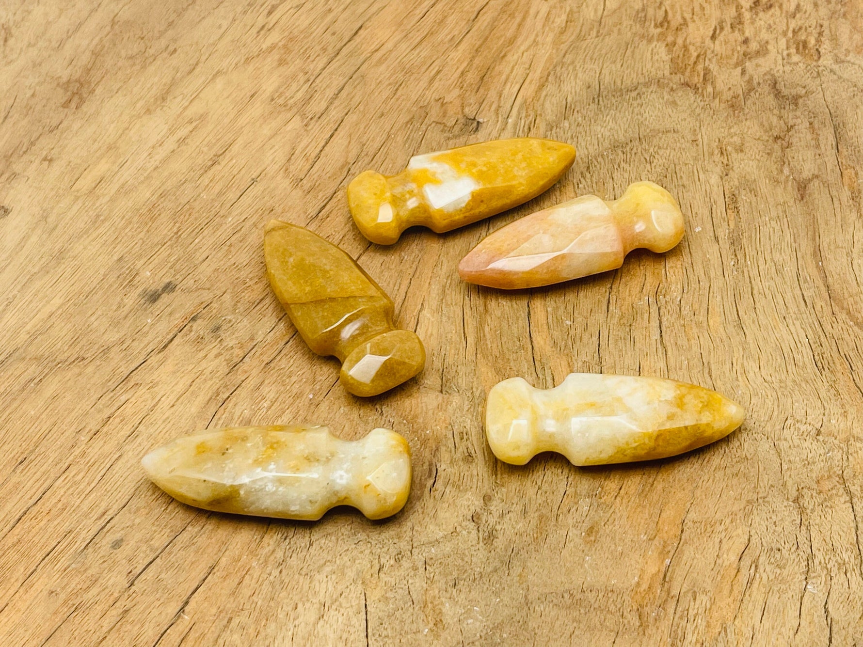 Yellow jade sword dagger carved gemstone, 50mm, with detailed carving and polished surface, suitable for jewelry or display.
