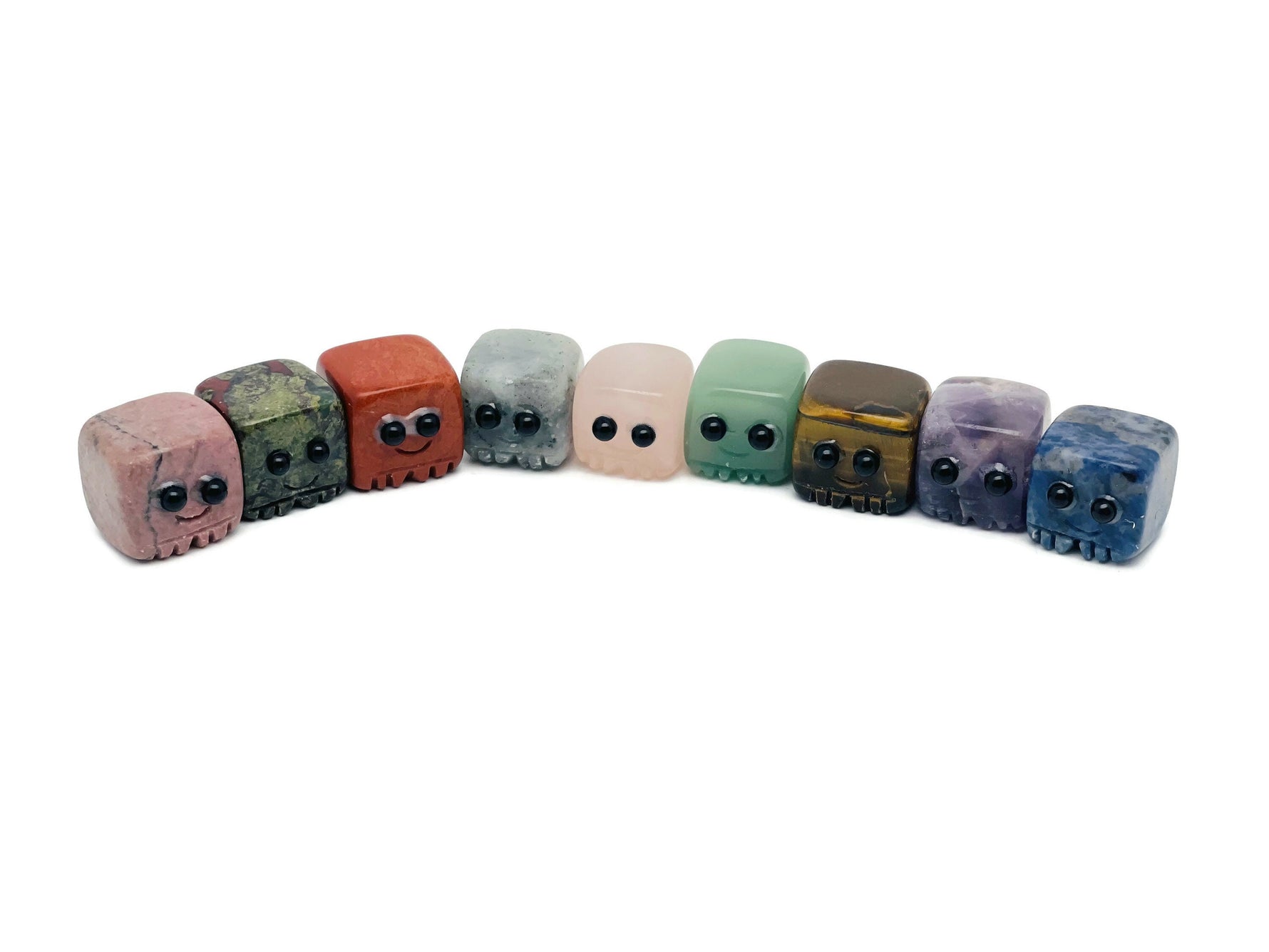 Hand-carved gemstone skull figurine from GemstoneGO, showcasing detailed craftsmanship and vibrant colors for healing and decor.