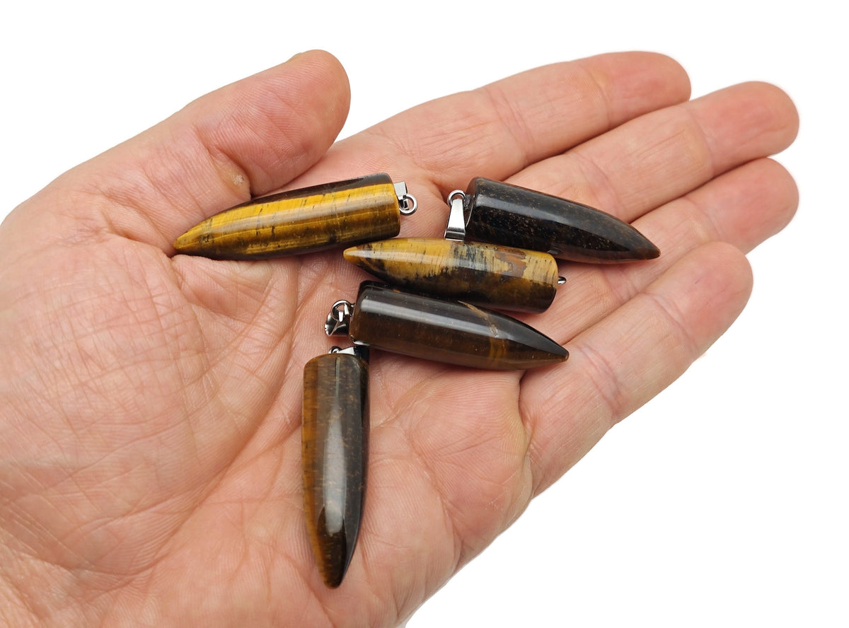 Polished tiger eye bullet gemstone pendant with carved details, showcasing warm brown and gold hues, from GemstoneGO.