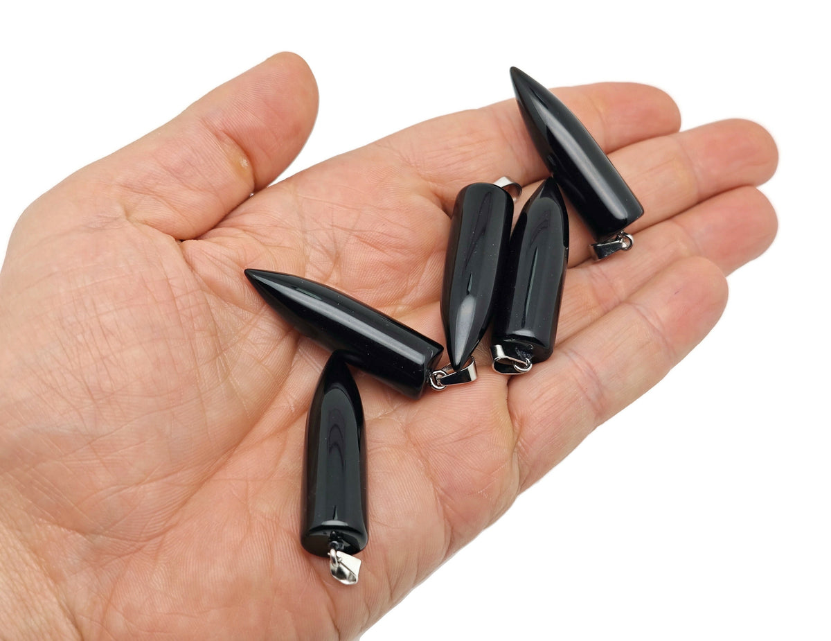 Polished black obsidian bullet gemstone pendant with carved details, hanging from a silver chain by GemstoneGO.