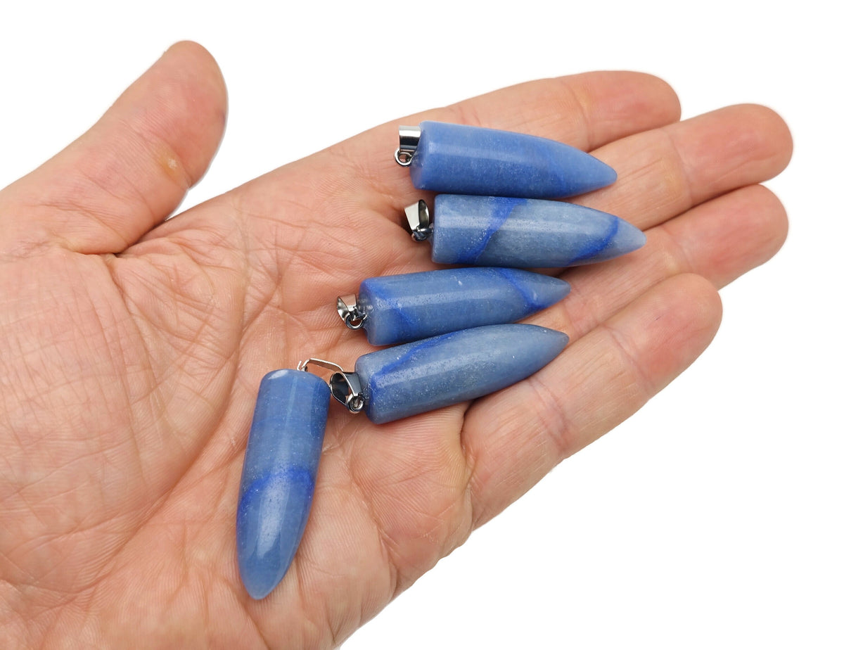 Polished blue aventurine bullet gemstone pendant with carved details, showcasing smooth, vibrant blue stone on a neutral background.