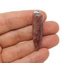 Polished strawberry quartz bullet gemstone pendant with carved details, showcasing a smooth, elongated shape and vibrant pink hue.