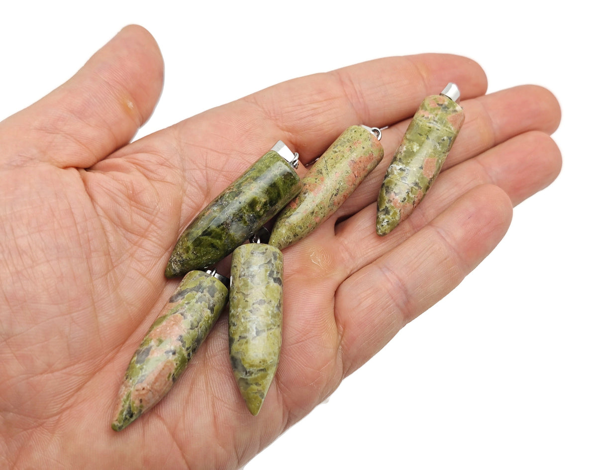 Polished Unakite bullet gemstone pendant with carved details, featuring a smooth, natural green and pink mineral appearance.