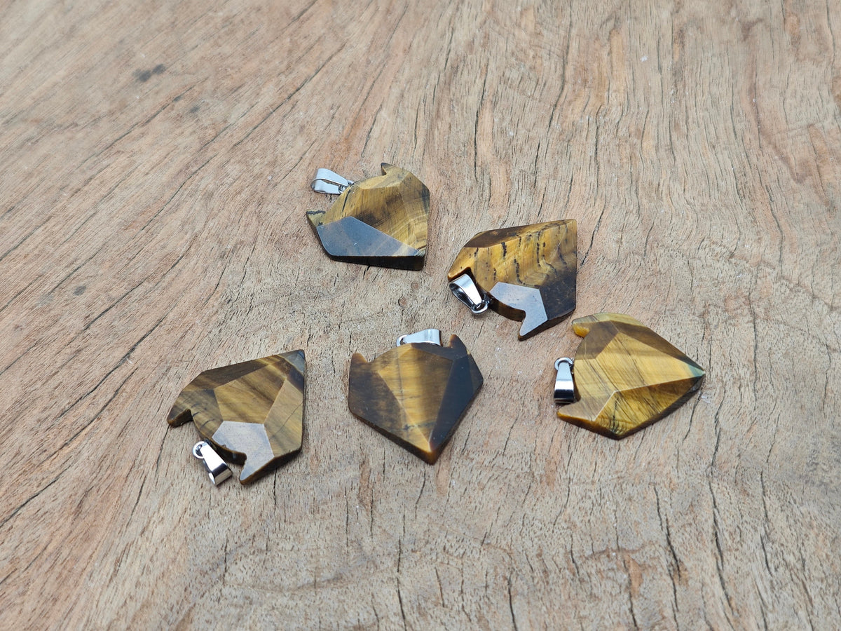 Tiger Eye wolf head gemstone pendant from GemstoneGO featuring a detailed crystal jewelry design with warm, golden-brown hues.