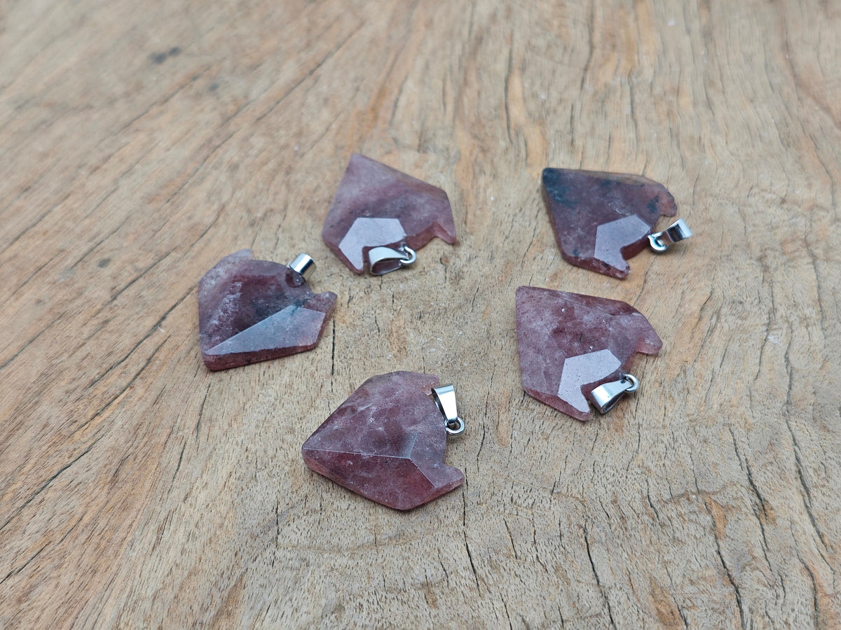 Strawberry quartz wolf head gemstone pendant from GemstoneGO, showcasing detailed crystal jewelry with a wolf motif.