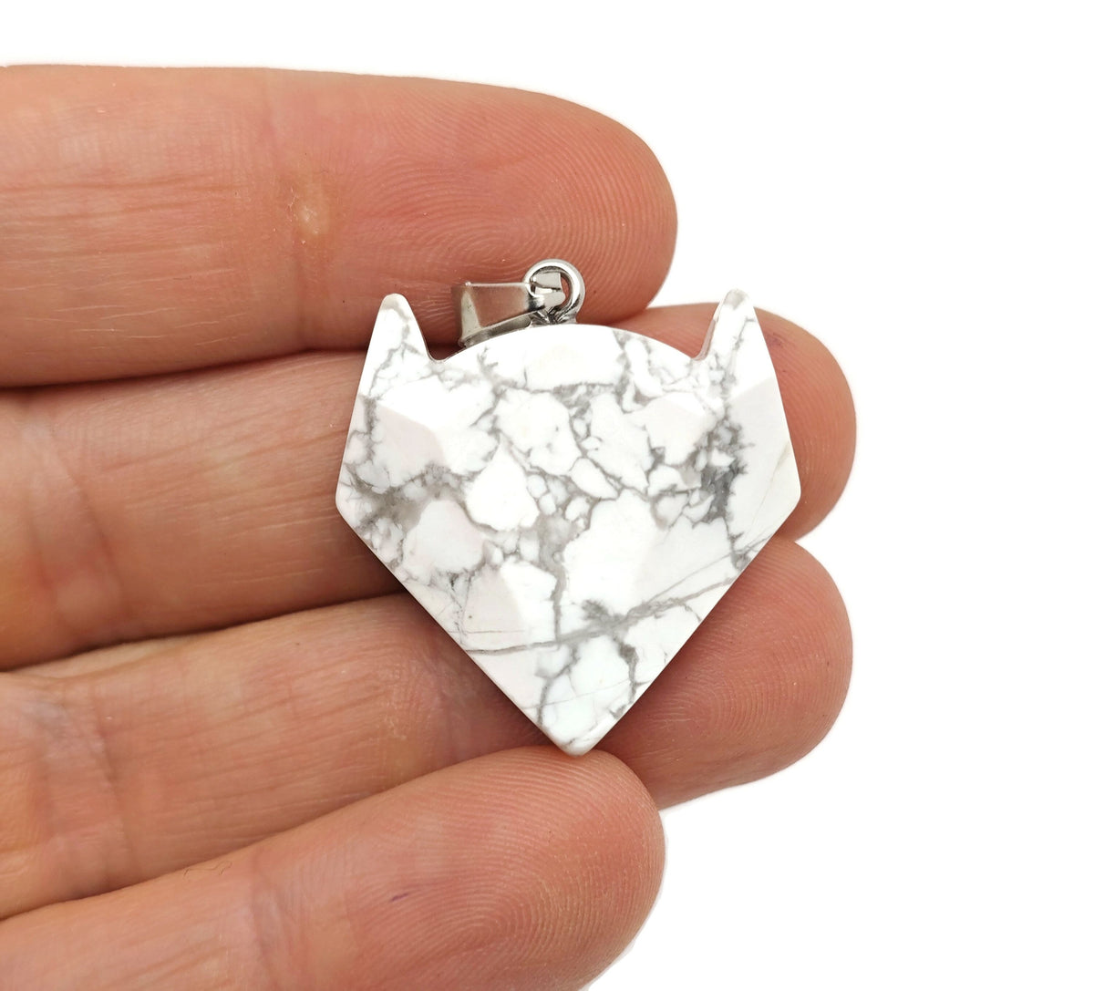 Howlite wolf head gemstone pendant from GemstoneGO, featuring a detailed crystal jewelry design with a polished finish.
