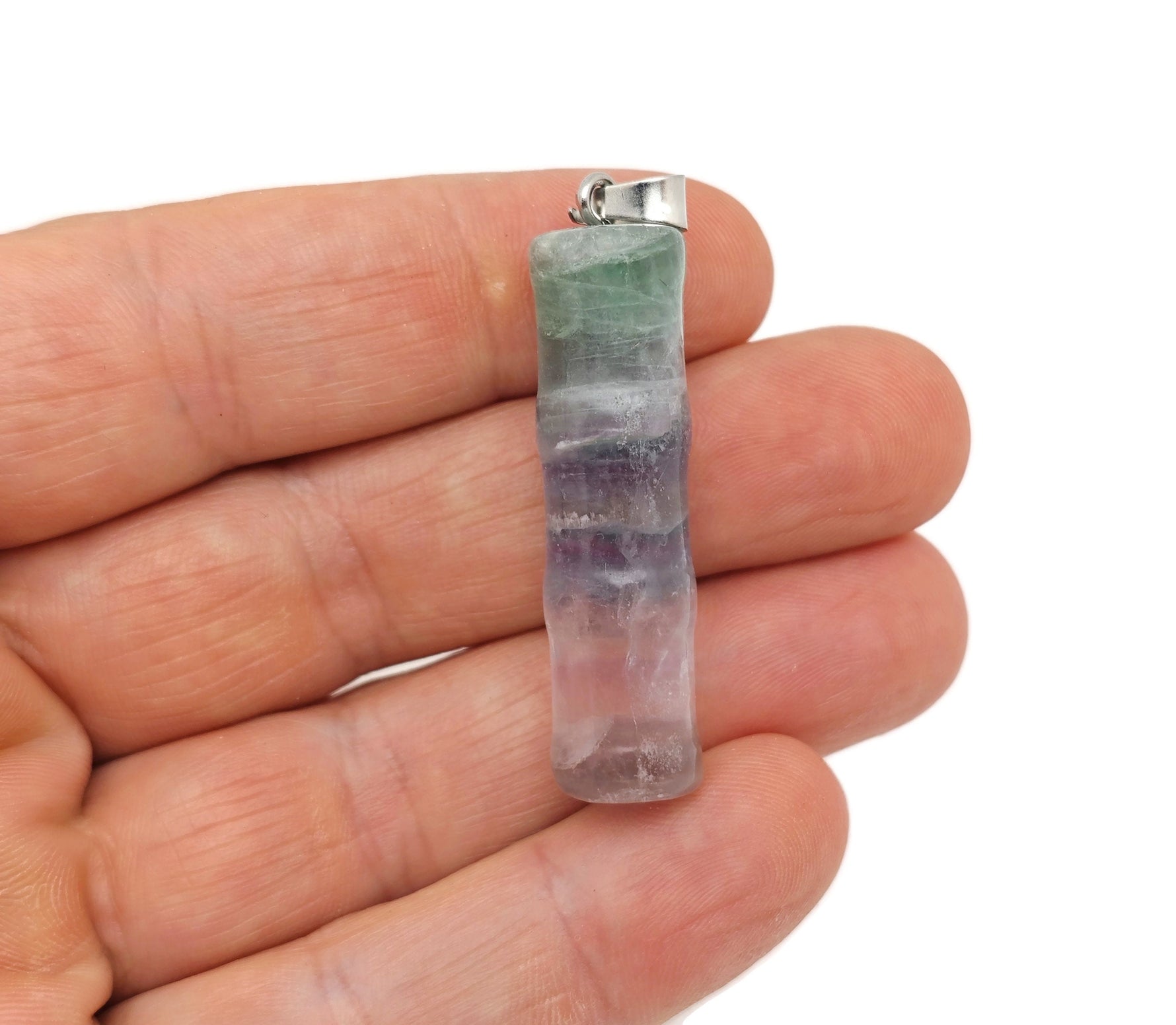 Fluorite bamboo-shaped crystal pendant from GemstoneGO, featuring vibrant green and purple hues and protective energy.