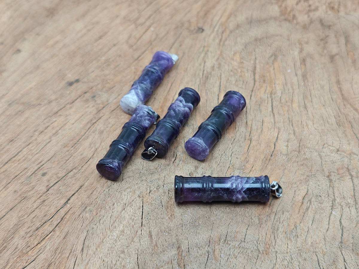 Amethyst bamboo-shaped crystal pendant from GemstoneGO, featuring a protective amethyst gemstone with intricate bamboo design.