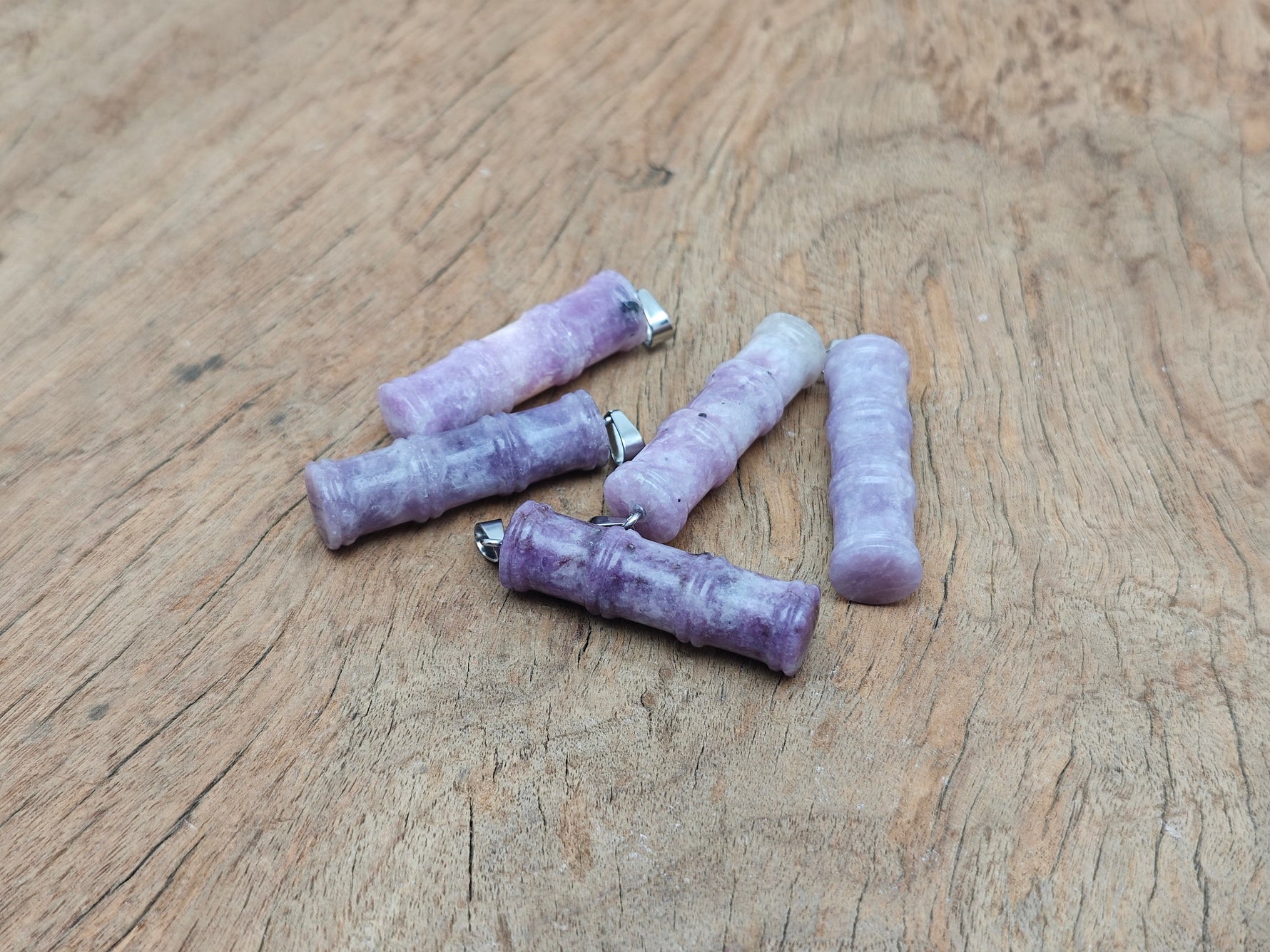 Lepidolite bamboo-shaped crystal pendant from GemstoneGO featuring a protective crystal design on a silver chain.