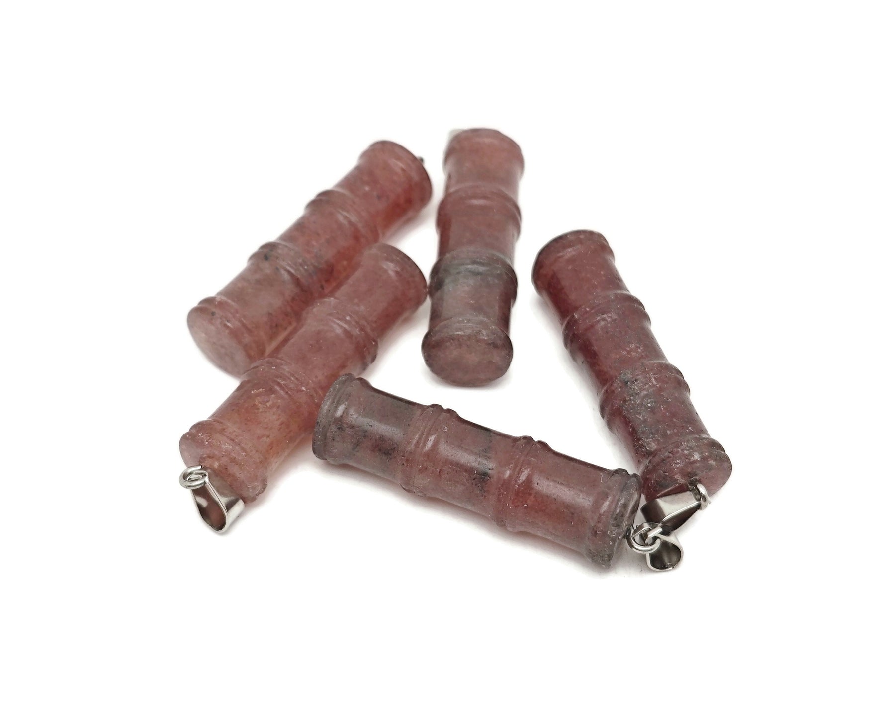 Strawberry Quartz bamboo-shaped crystal pendant from GemstoneGO, featuring a protective crystal design with vibrant pink hue.