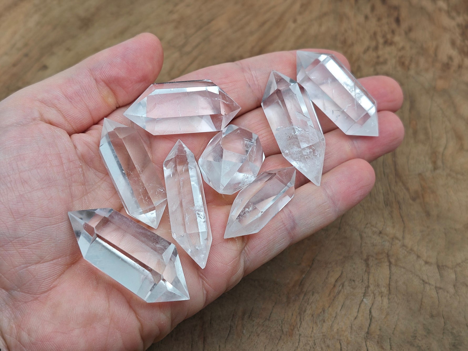 Clear quartz double terminated point wand from GemstoneGO, showing a polished, transparent quartz crystal with pointed ends.