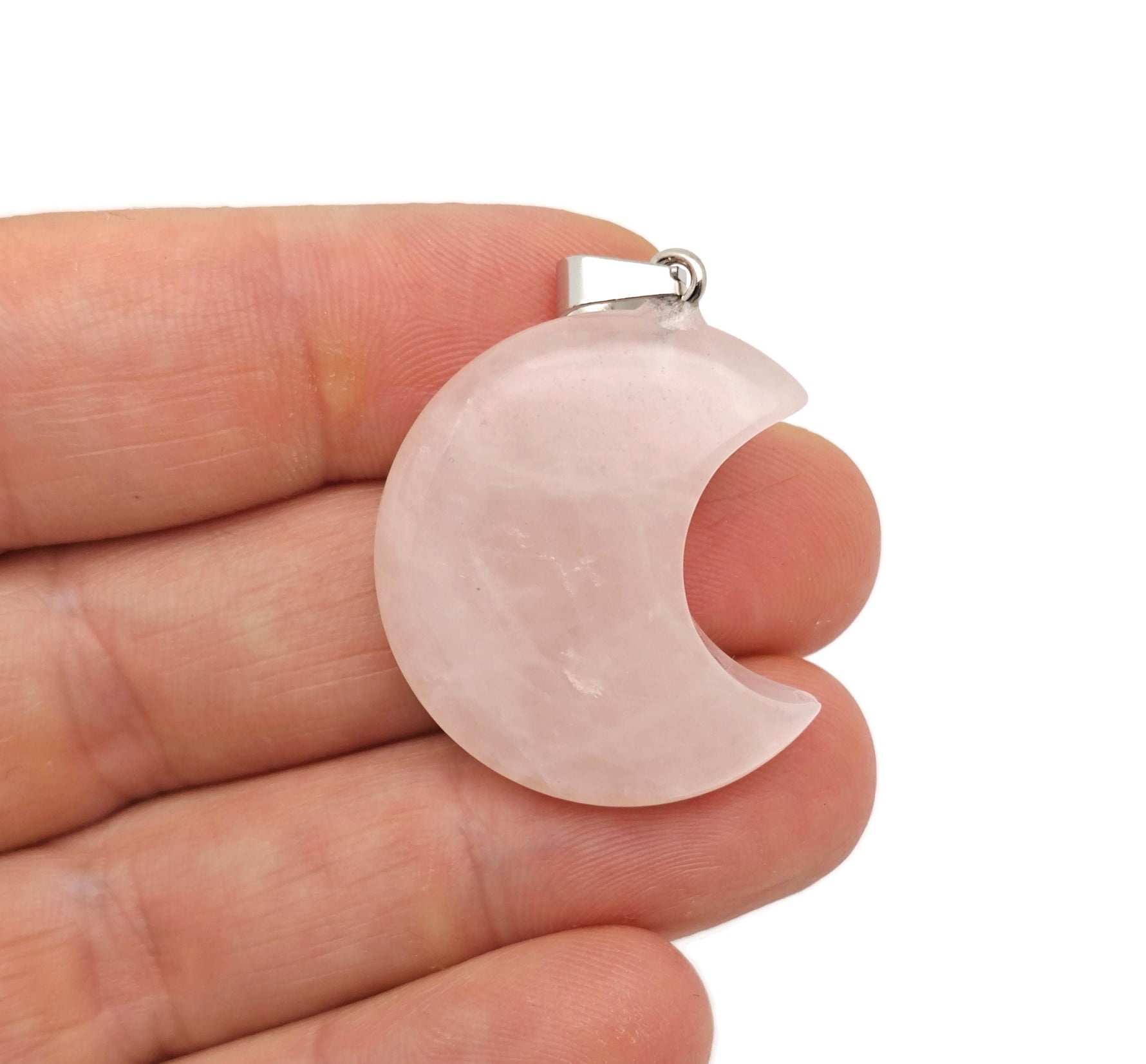 Rose quartz moon gemstone pendant featuring a crescent moon design from GemstoneGO, showcasing its soft pink color and polished surface.