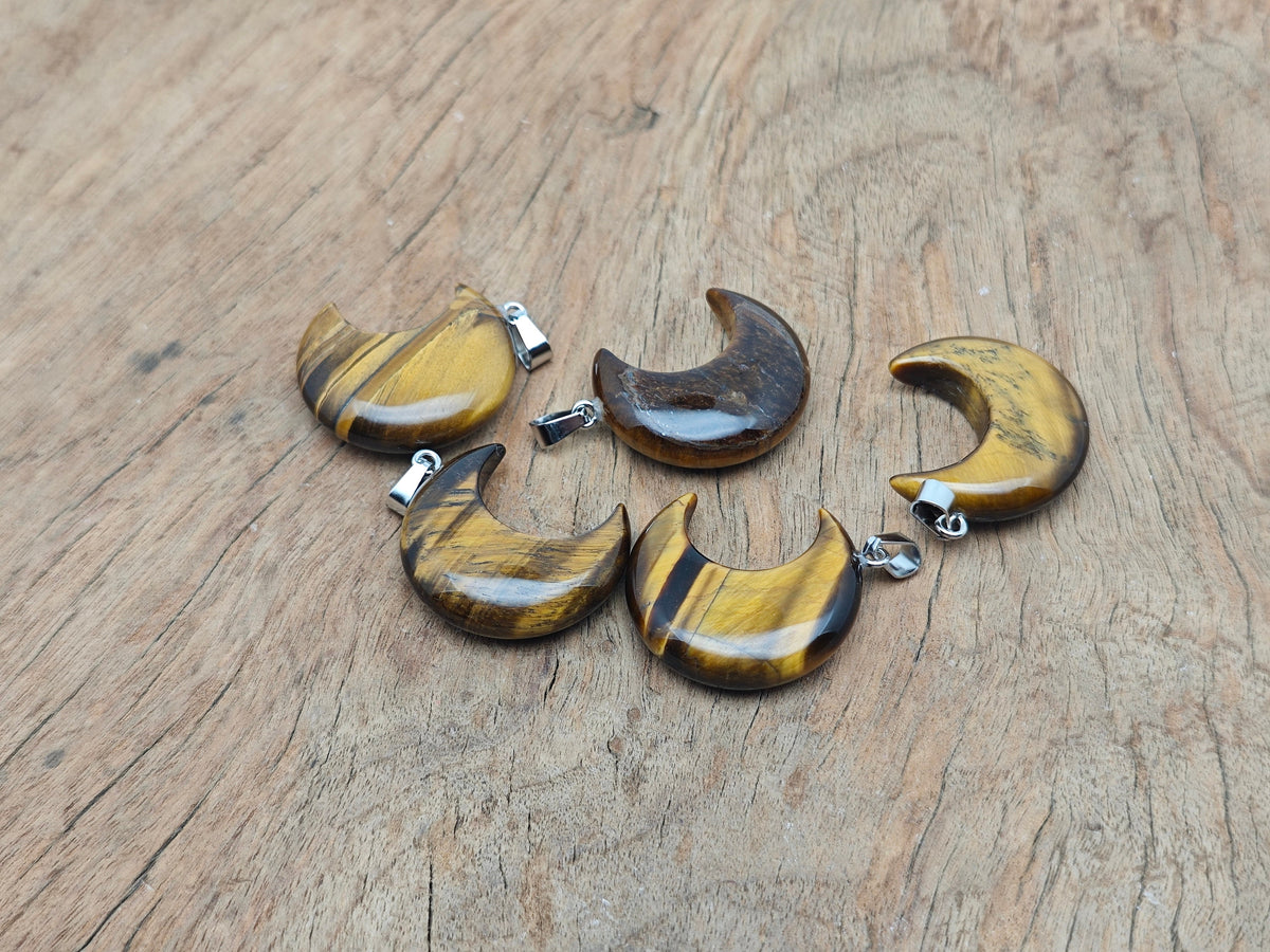 Tiger Eye moon pendant featuring a crescent moon design from GemstoneGO, showcasing the polished gemstone with a silver bail.
