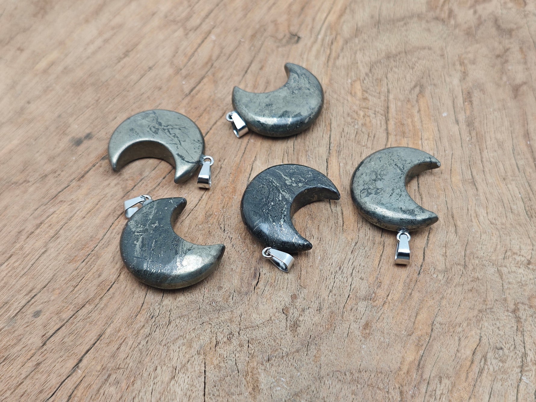 Pyrite moon gemstone pendant featuring a crescent moon design by GemstoneGO, showcasing the metallic luster and natural stone details.