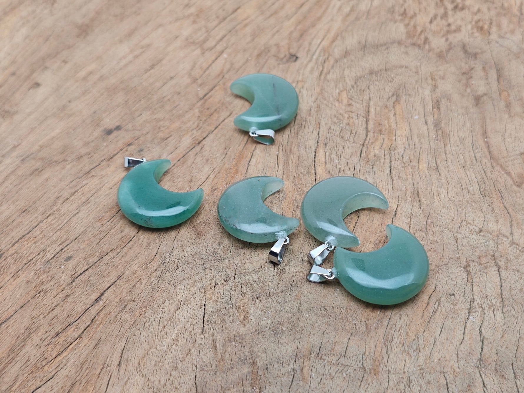 Aventurine moon gemstone pendant featuring a crescent moon shape, crafted by GemstoneGO, with smooth green aventurine stone.
