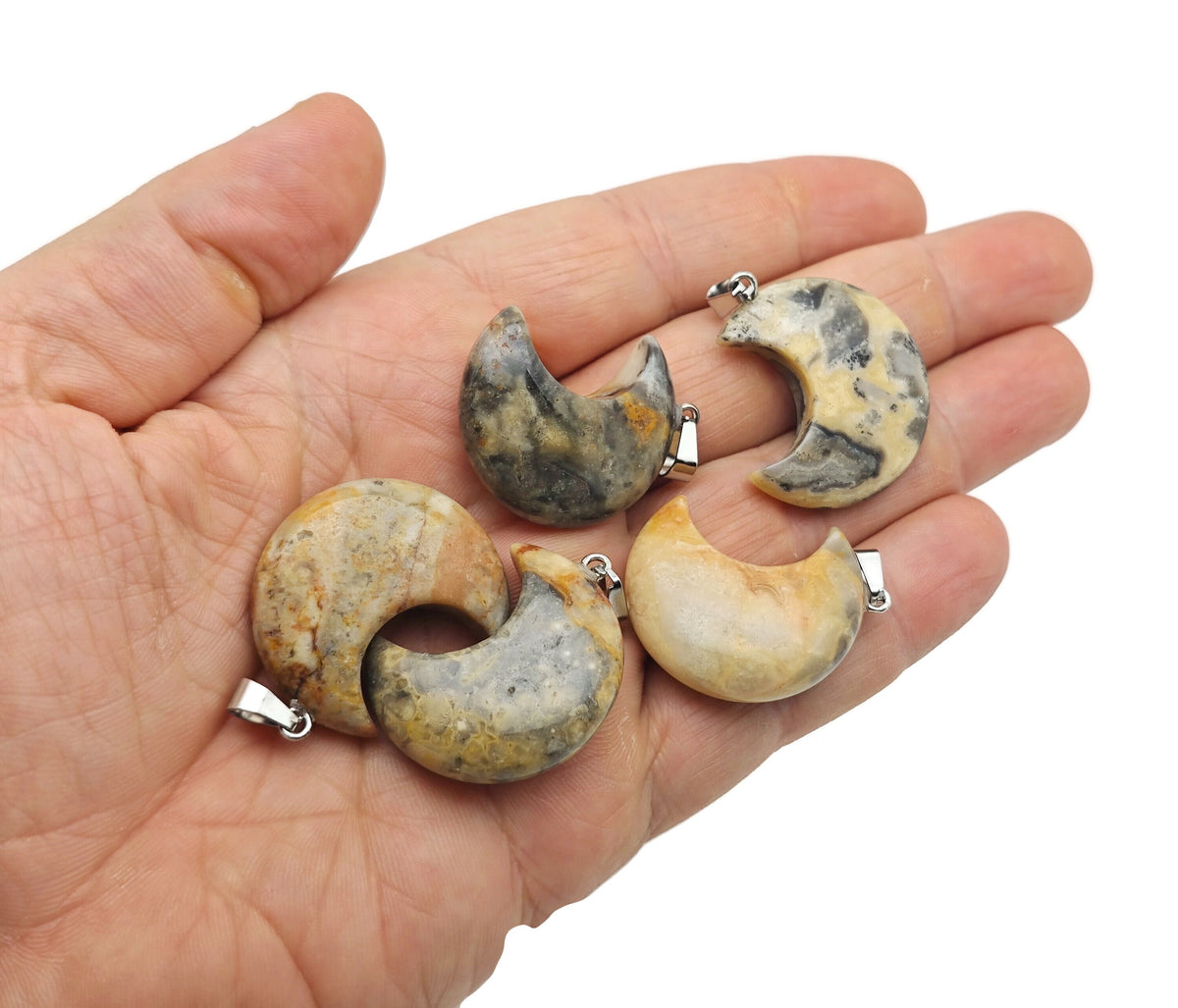 Crazy Lace Agate moon gemstone pendant featuring a crescent moon design by GemstoneGO, showcasing intricate patterns and vibrant colors.