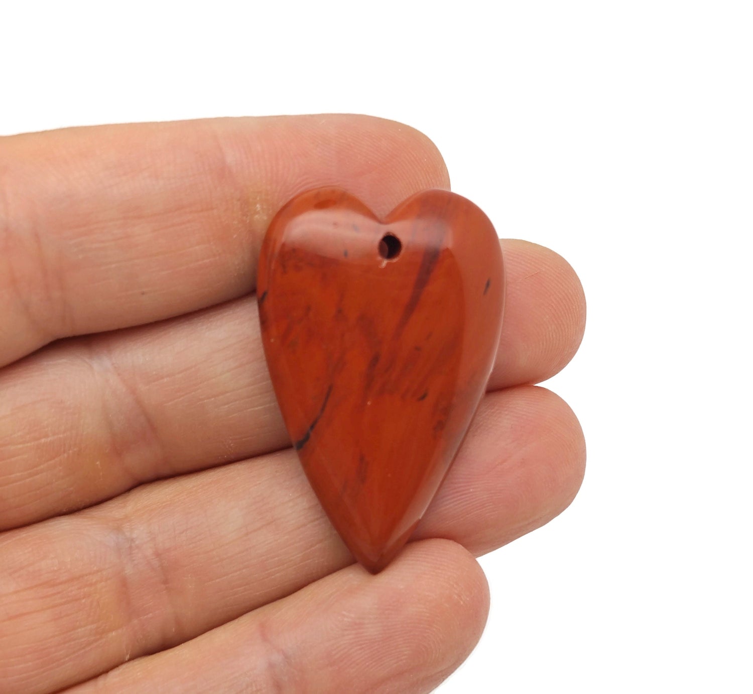 Red Jasper long heart-shaped love crystal pendant by GemstoneGO, featuring a heart-shaped healing gemstone on a silver chain.