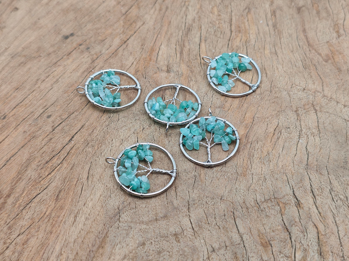 A gemstone Aventurine Tree of Life pendant featuring intricate wire wrapping and a vibrant green gemstone, handcrafted jewelry.