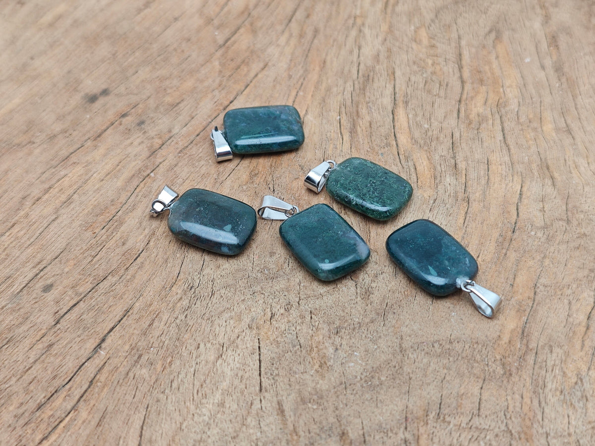 Moss agate crystal pendant in a rectangular shape with natural green and brown patterns, from GemstoneGO.