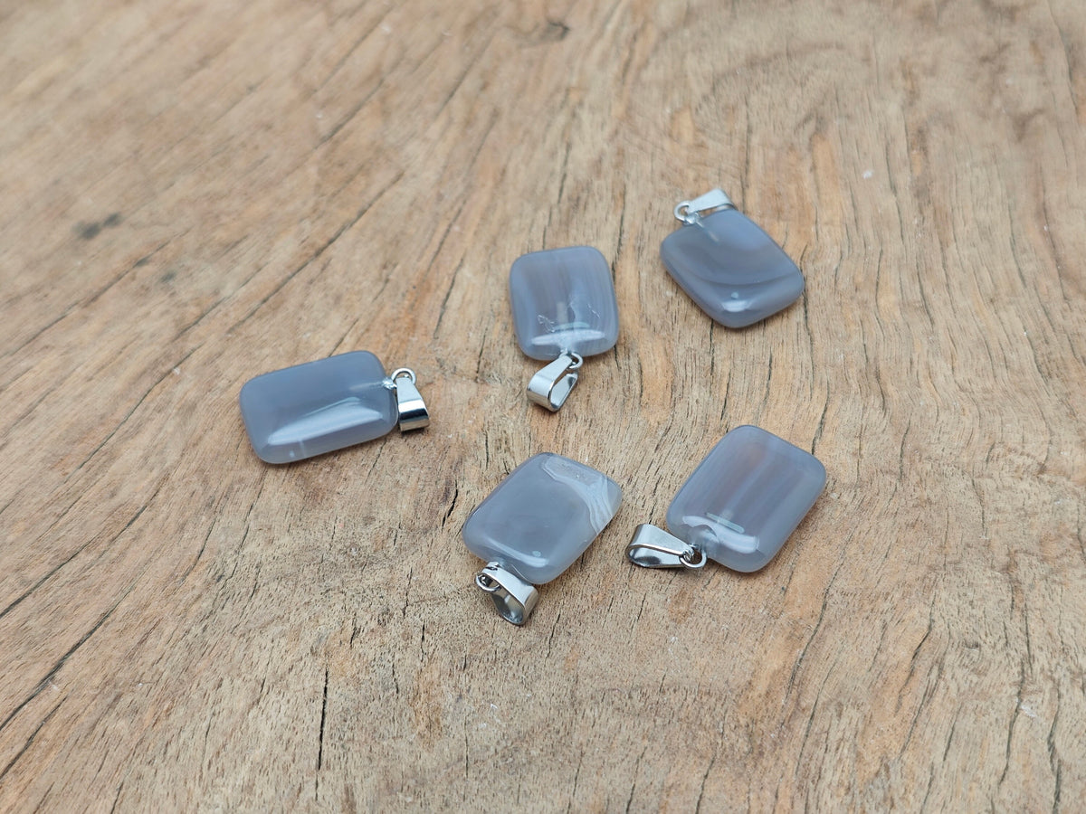 Grey agate rectangle-shaped crystal pendant from GemstoneGO, showcasing the polished stone with natural banding and smooth edges.