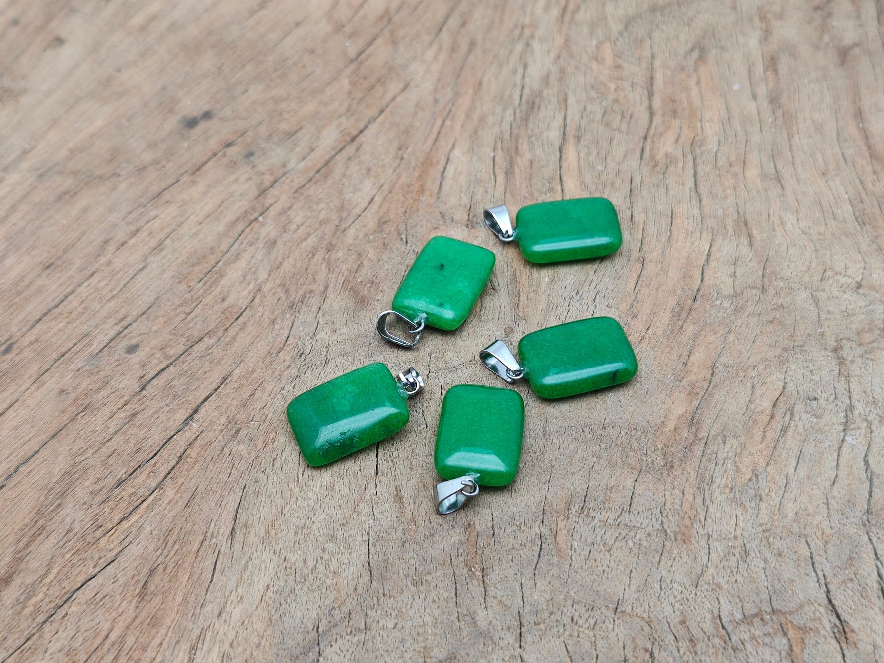 Green agate rectangle crystal pendant from GemstoneGO, featuring a polished rectangular shape and vibrant green color.