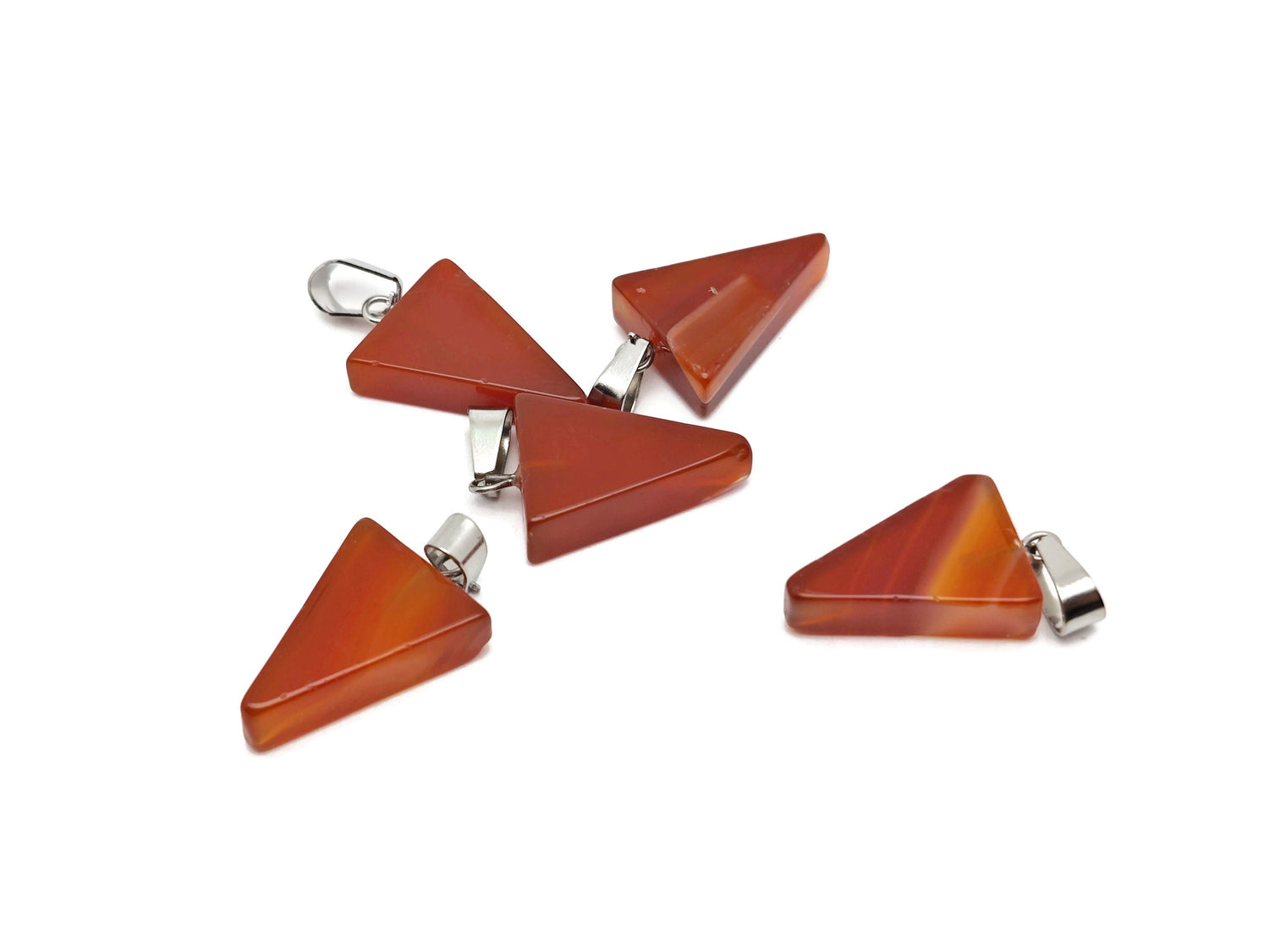Carnelian triangle-shaped crystal pendant from GemstoneGO, showcasing vibrant orange gemstone with natural facets.