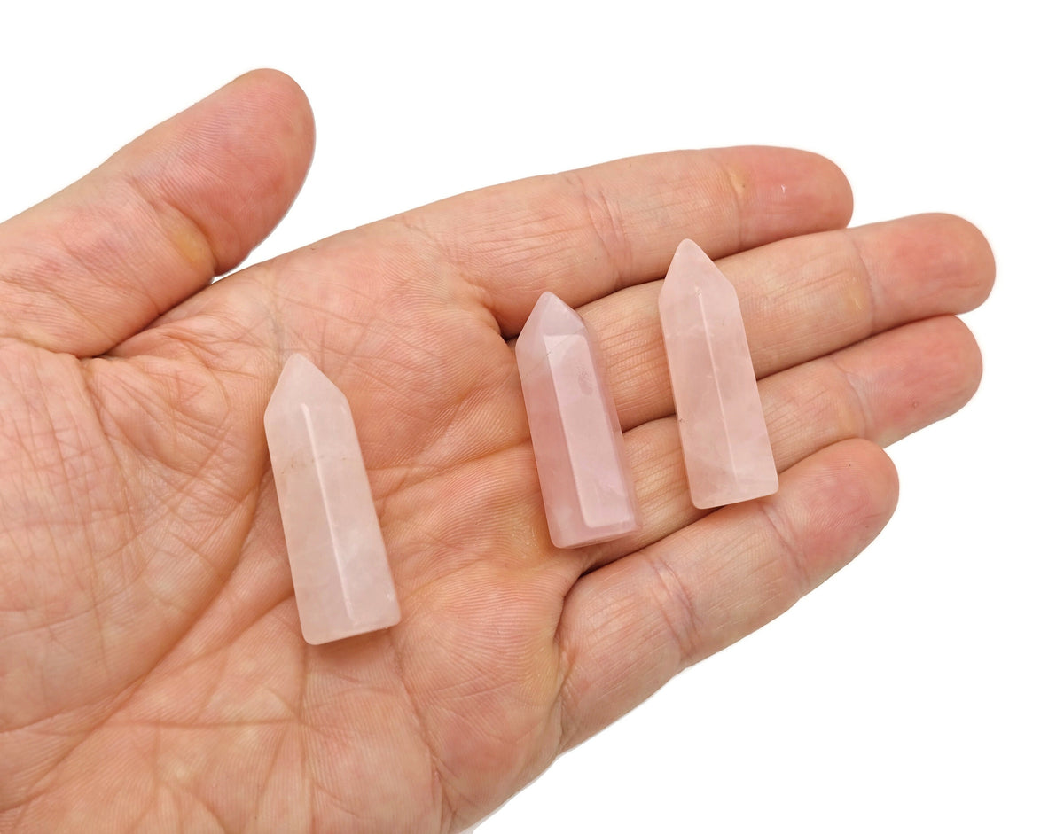Rose quartz obelisk tower crystal from GemstoneGO, 40mm, showcasing a pink, polished gemstone with natural crystal details.