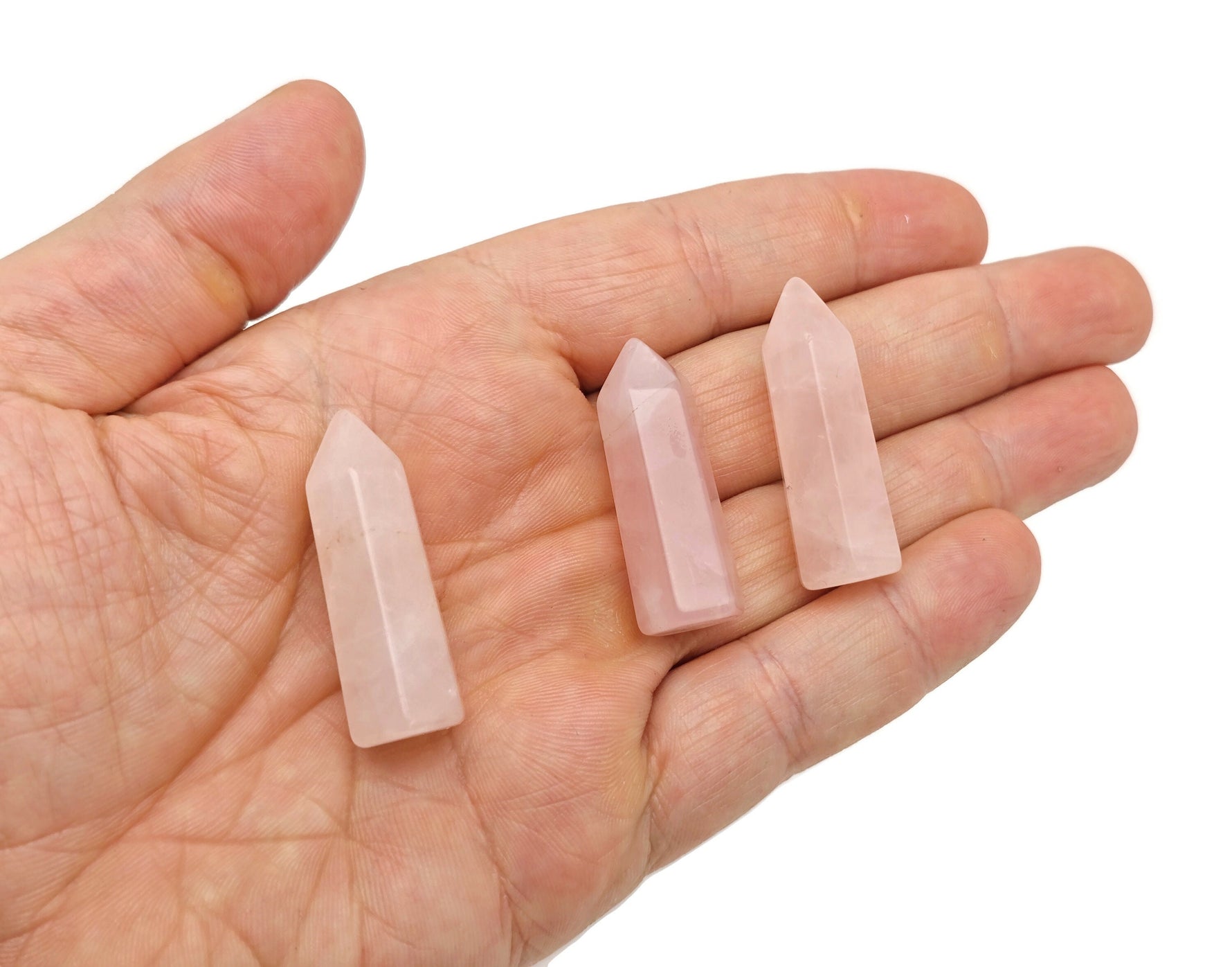 Rose quartz obelisk tower crystal from GemstoneGO, 40mm, showcasing a pink, polished gemstone with natural crystal details.