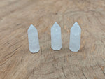 Clear quartz obelisk tower crystal, 40mm, from GemstoneGO, showcasing a polished, pointed gemstone with natural clarity and facets.