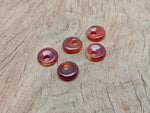 Carnelian crystal donut pendant from GemstoneGO, 18mm Pi stone with vibrant orange color and smooth polished surface.