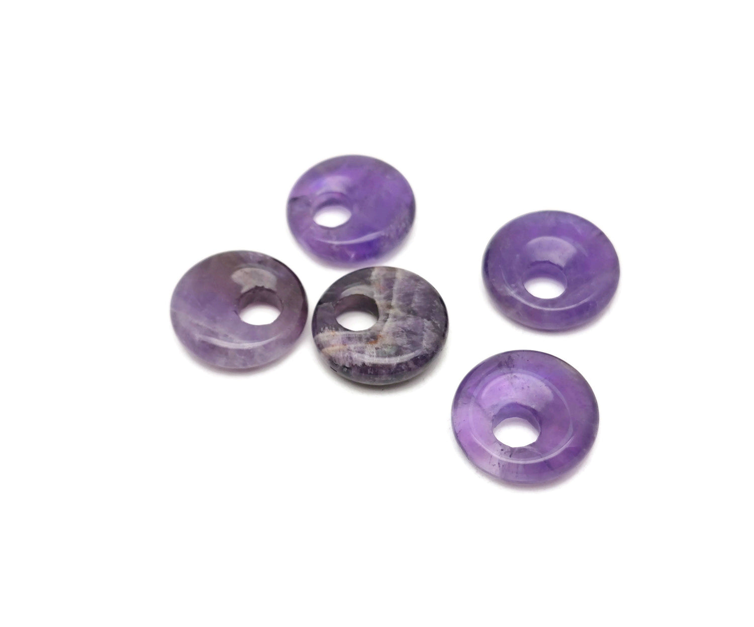 Amethyst crystal donut pendant from GemstoneGO, 18mm Pi stone with purple amethyst gemstone and polished, rounded shape.