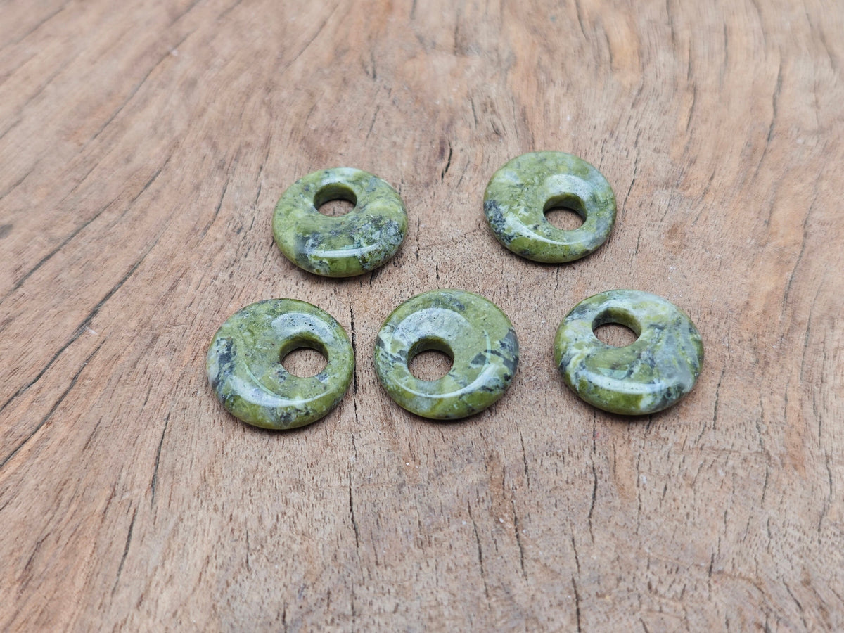 Unakite crystal donut pendant, 18mm Pi stone from GemstoneGO, featuring vibrant green and pink hues, polished and smooth surface.