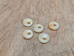 Yellow jade crystal donut pendant, 18mm Pi stone from GemstoneGO, showcasing a smooth, polished yellow jade gemstone with a donut shape.